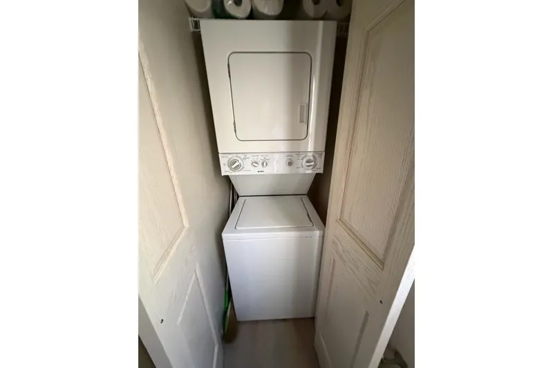 Slide: The Image of Stacked washer and dryer in a 2002 Fantasy 16 X 68 houseboat laundry area. - 37