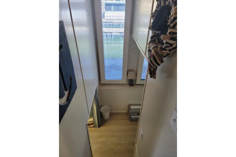 Slide: The Image of Narrow hallway inside 2002 Fantasy 16 X 68 houseboat with window and decor. - 38