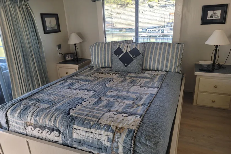 Slide: The Image of Cozy bedroom in a 2002 Fantasy 16 X 68 houseboat with nautical-themed decor. - 41