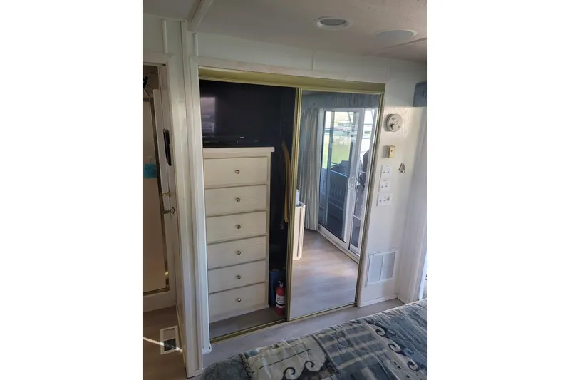 Slide: The Image of Interior of 2002 Fantasy houseboat with mirrored closet and dresser. - 44
