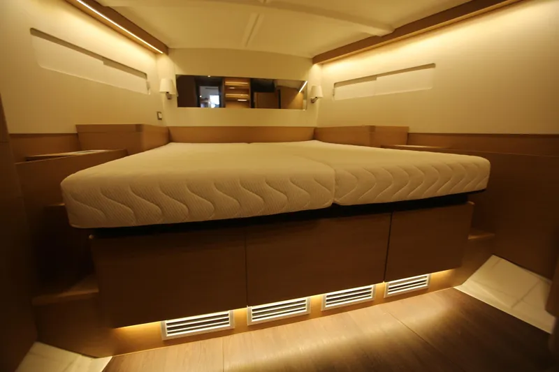 Slide: The Image of Interior of 2023 Jeanneau Sun Odyssey 490 yacht, featuring modern kitchen and seating area. - 12