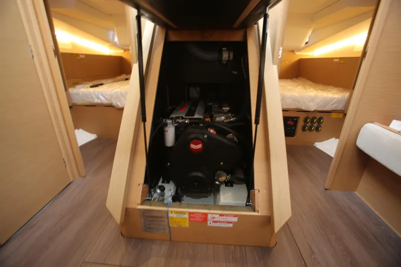 Slide: The Image of Interior of 2023 Jeanneau Sun Odyssey 490 yacht, featuring modern kitchen and seating area. - 16