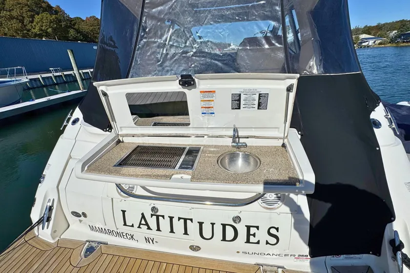 Slide: The Image of 2017 Sea Ray Sundancer 350 Coupe with outdoor kitchenette at marina. - 10