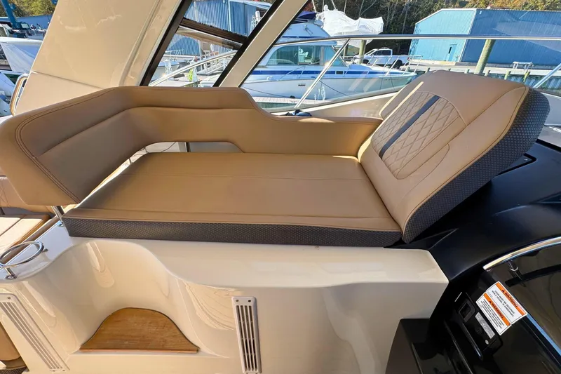 Slide: The Image of Luxurious seating on 2017 Sea Ray Sundancer 350 Coupe yacht, featuring tan upholstery. - 14