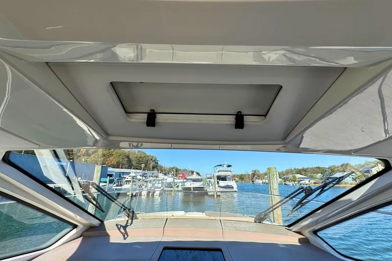 Slide: The Image of Interior view from 2017 Sea Ray Sundancer 350 Coupe, overlooking marina with boats. - 15