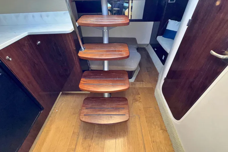 Slide: The Image of Interior of 2017 Sea Ray Sundancer 350 Coupe with wooden steps and modern design. - 17