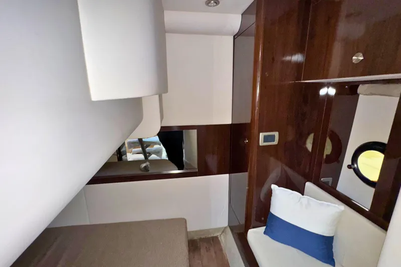 Slide: The Image of Interior of 2017 Sea Ray Sundancer 350 Coupe with wood paneling and cozy seating. - 20