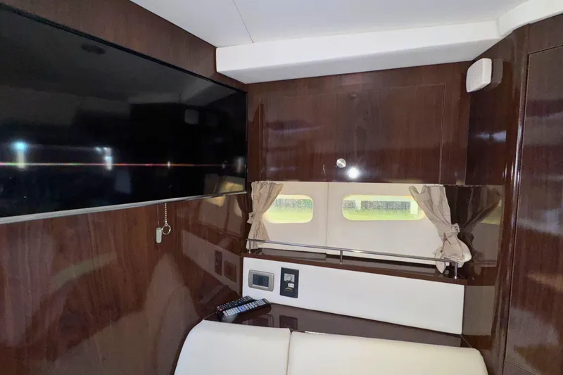 Slide: The Image of Interior of 2017 Sea Ray Sundancer 350 Coupe with TV and wood paneling. - 26