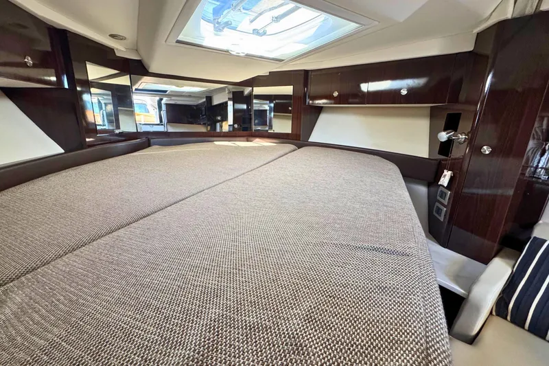 Slide: The Image of Luxurious interior of 2017 Sea Ray Sundancer 350 Coupe with spacious bed and elegant wood finish. - 31