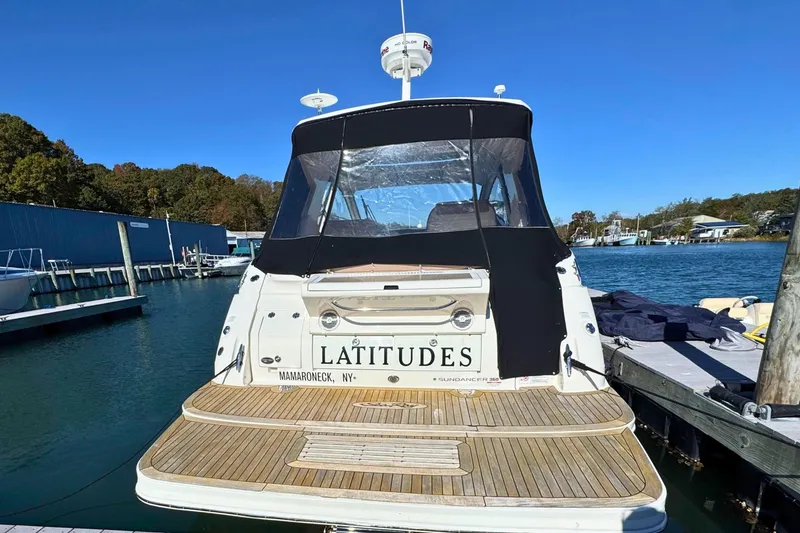 Slide: The Image of 2017 Sea Ray Sundancer 350 Coupe docked, rear view with "Latitudes" name visible. - 8
