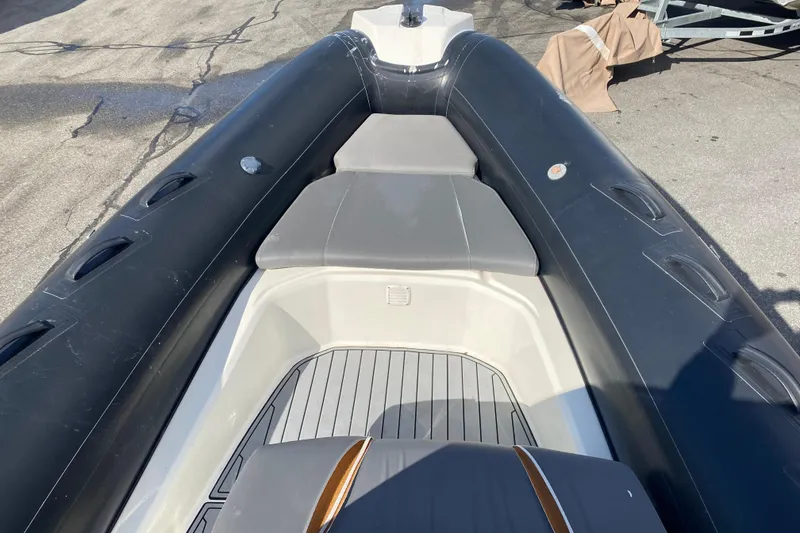 Slide: The Image of 2019 Brig Eagle 650 boat with Yamaha 200 engine, parked outdoors under blue sky. - 4