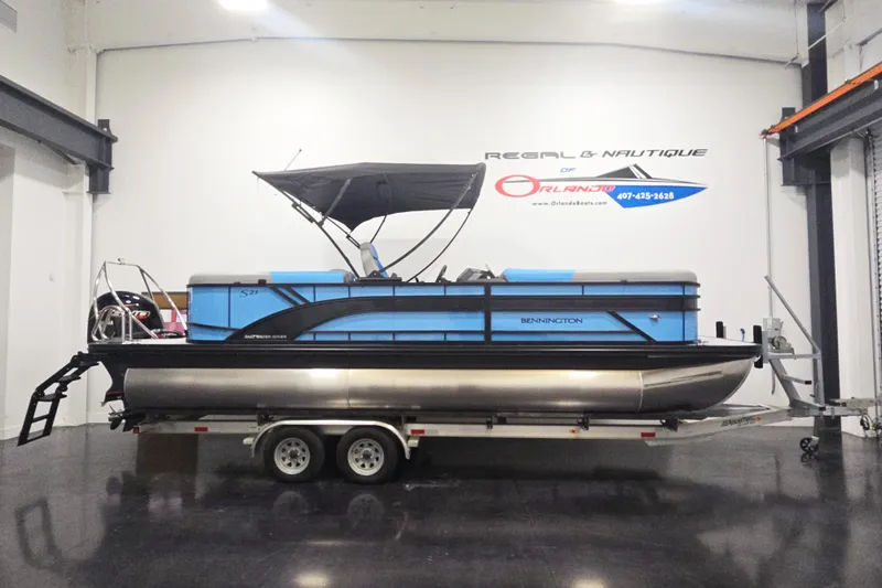 Slide: The Image of 2026 Bennington 23SSRSF pontoon boat on trailer in showroom. - 1