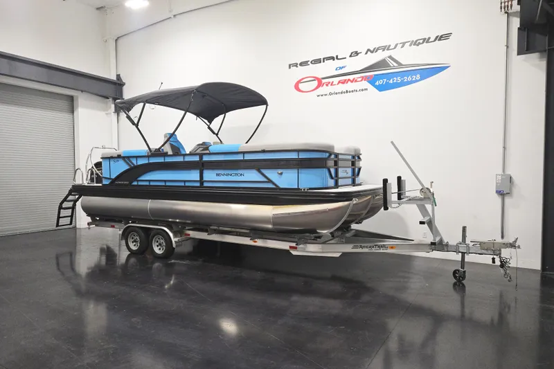 Slide: The Image of 2026 Bennington 23SSRSF pontoon boat on trailer in showroom. - 2