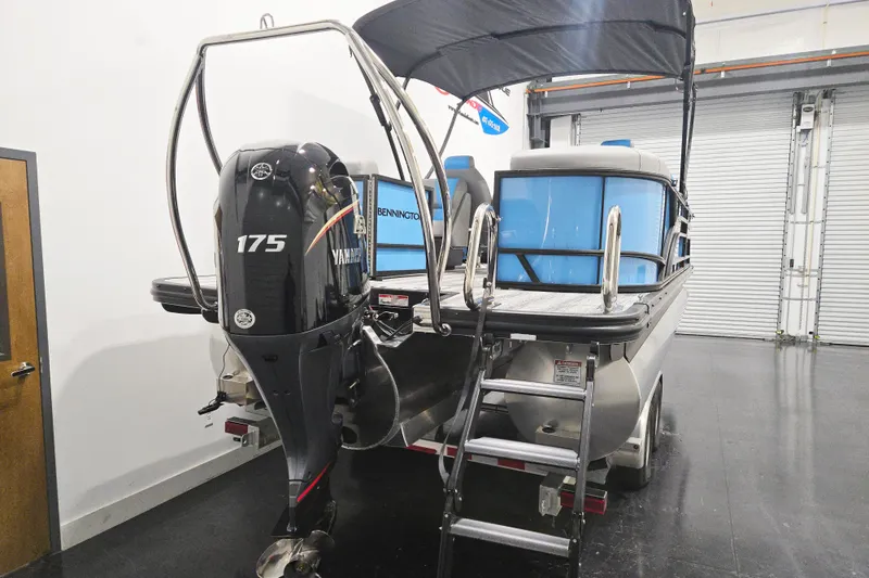 Slide: The Image of 2026 Bennington 23SSRSF pontoon boat with Yamaha 175 engine in a garage. - 3