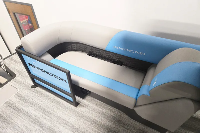 Slide: The Image of 2026 Bennington 23SSRSF boat seating with blue and gray upholstery, showcasing brand logo. - 6