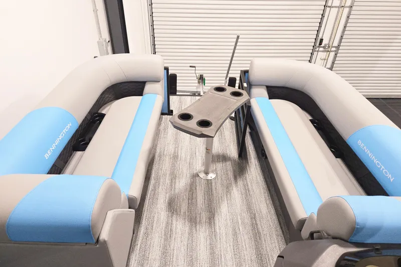 Slide: The Image of 2026 Bennington 23SSRSF boat interior with gray and blue seating, featuring a central table. - 7