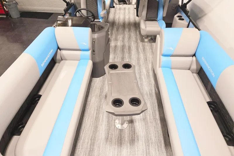 Slide: The Image of 2026 Bennington 23SSRSF pontoon boat interior with blue and gray seating and cup holders. - 8