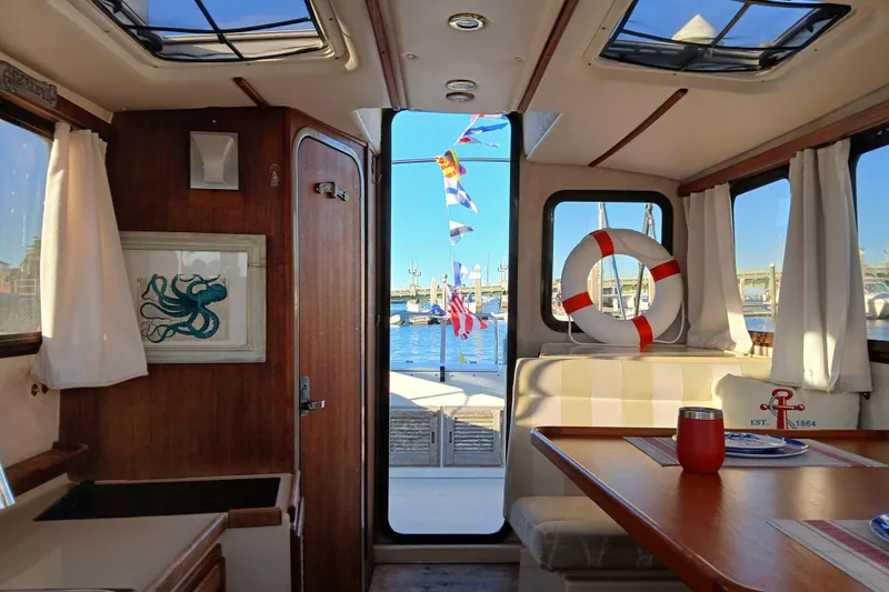 Slide: The Image of Interior of 2009 Ranger Tugs R-25 boat with nautical decor and marina view. - 12