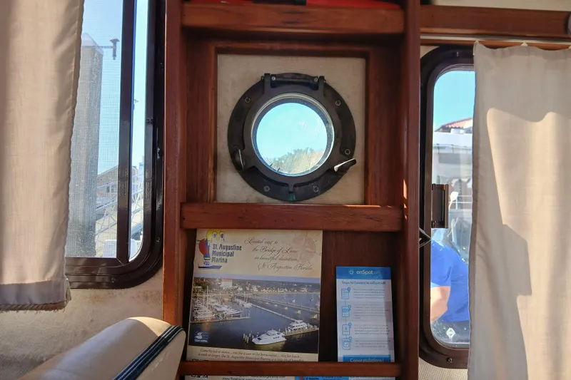 Slide: The Image of Interior of 2009 Ranger Tugs R-25 with porthole and marina brochure. - 16