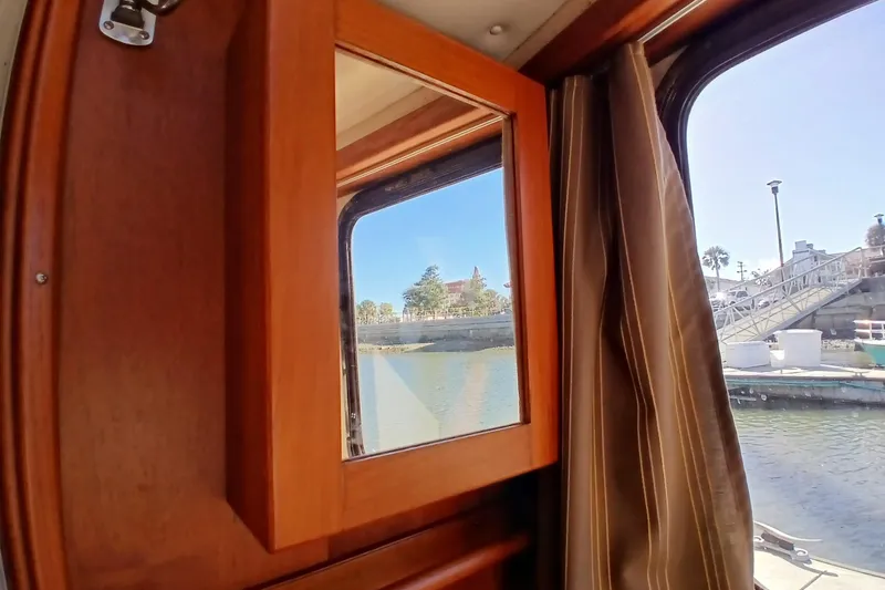 Slide: The Image of Interior view from 2009 Ranger Tugs R-25 boat window, overlooking marina and waterfront. - 21