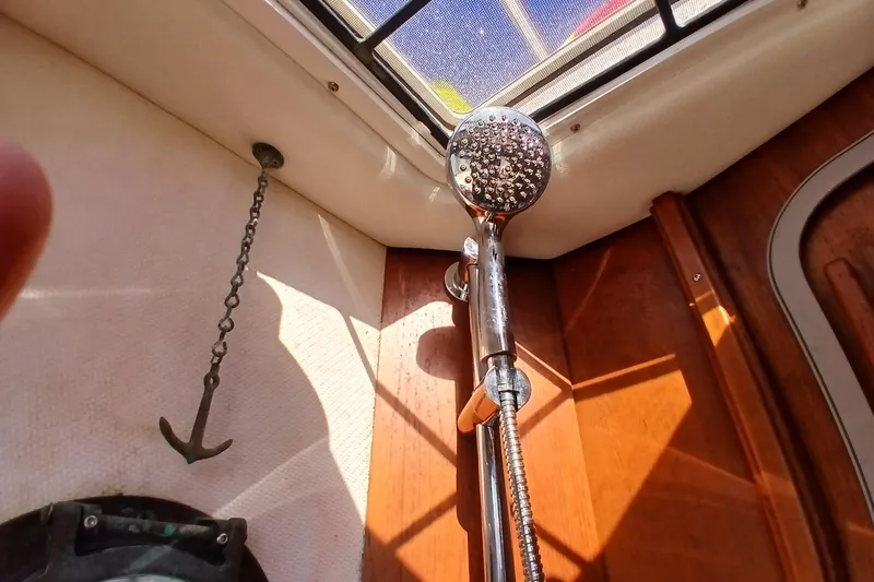 Slide: The Image of Interior of 2009 Ranger Tugs R-25 boat with showerhead and anchor decor. - 23