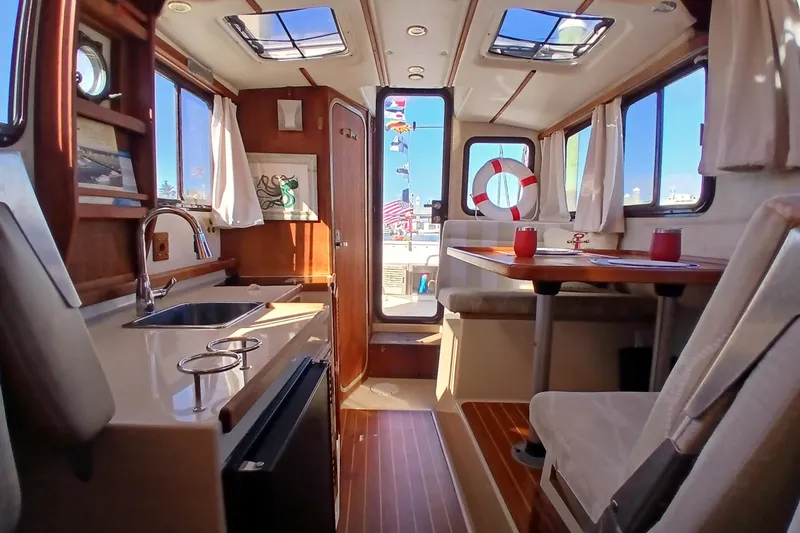 Slide: The Image of Interior of 2009 Ranger Tugs R-25 boat with kitchen and dining area. - 24