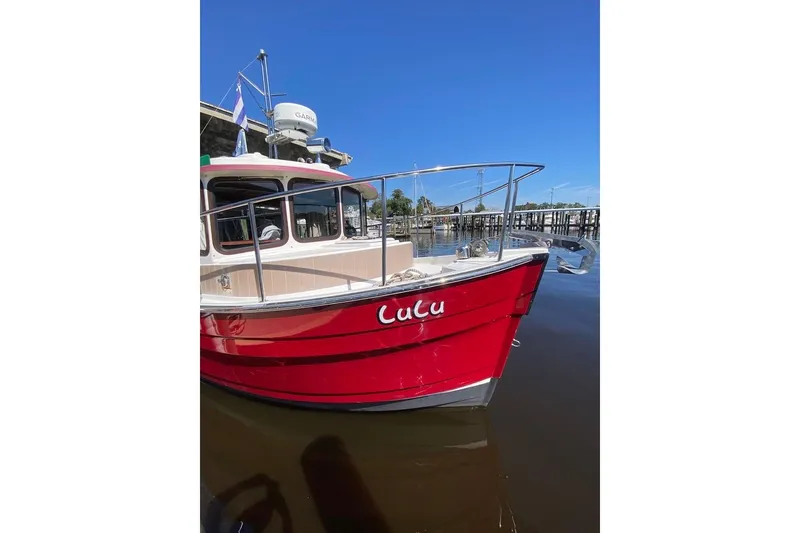 Slide: The Image of Red 2009 Ranger Tugs R-25 boat docked, featuring "Lulu" on the hull. - 3