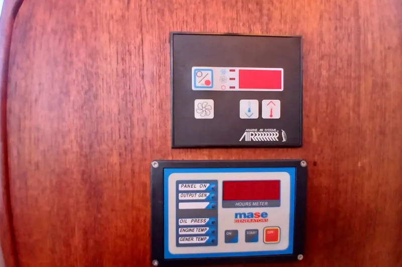 Slide: The Image of Control panels on 2009 Ranger Tugs R-25 boat, featuring marine air systems and generator meters. - 33