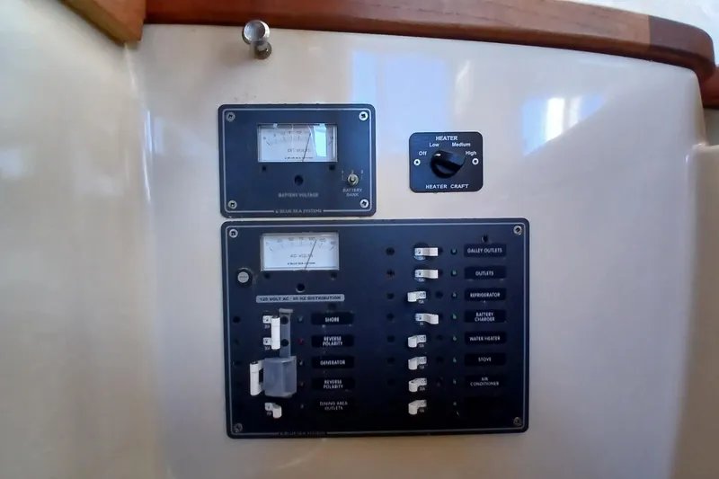 Slide: The Image of Electrical control panel on a 2009 Ranger Tugs R-25 boat, featuring voltage meters and switches. - 34