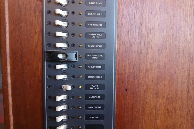 Slide: The Image of Control panel of a 2009 Ranger Tugs R-25 boat with labeled switches. - 35