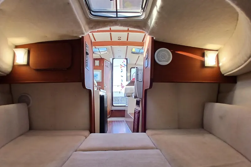 Slide: The Image of Interior of 2009 Ranger Tugs R-25 boat, featuring cozy seating and elegant wood finishes. - 38