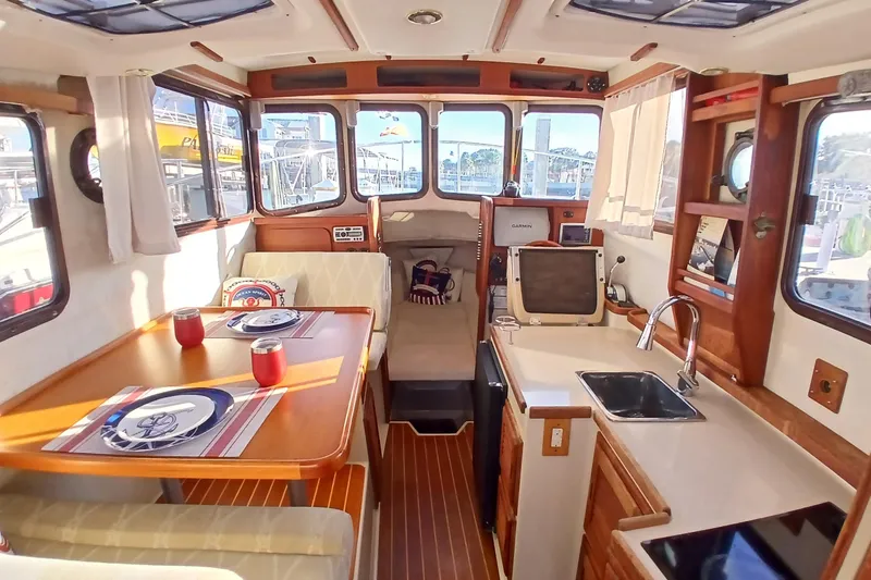 Slide: The Image of Interior of 2009 Ranger Tugs R-25 boat with dining area and kitchenette. - 4