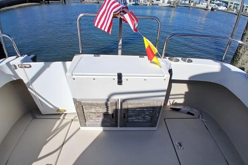 Slide: The Image of 2009 Ranger Tugs R-25 boat deck with flags, docked at marina. - 41
