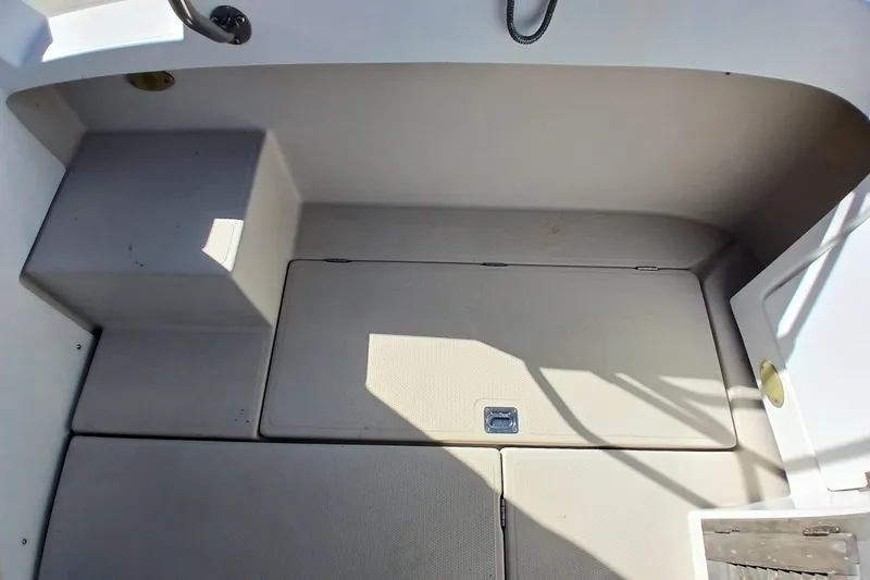 Slide: The Image of 2009 Ranger Tugs R-25 boat interior with storage compartment and seating area. - 42