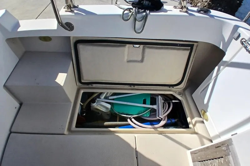 Slide: The Image of Storage compartment on a 2009 Ranger Tugs R-25 boat, containing cleaning supplies and equipment. - 44