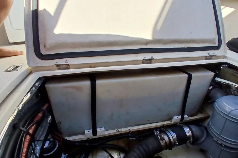 Slide: The Image of 2009 Ranger Tugs R-25 engine compartment with storage and mechanical components. - 45