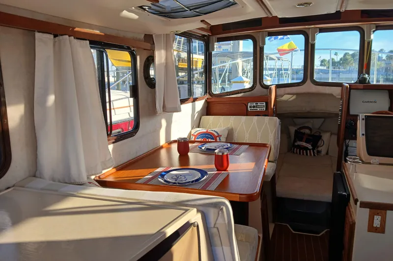 Slide: The Image of Interior of 2009 Ranger Tugs R-25 boat with dining area and nautical decor. - 5