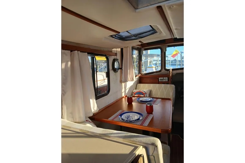 Slide: The Image of Interior of 2009 Ranger Tugs R-25 with dining area and nautical decor. - 8