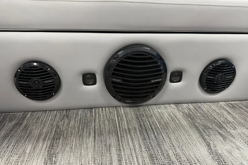 Slide: The Image of 2026 Bentley Pontoons Elite 223 Swingback interior speakers on a textured floor. - 12