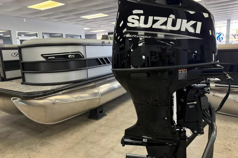 Slide: The Image of 2026 Bentley Pontoons Elite 223 Swingback with Suzuki outboard motor in showroom. - 14
