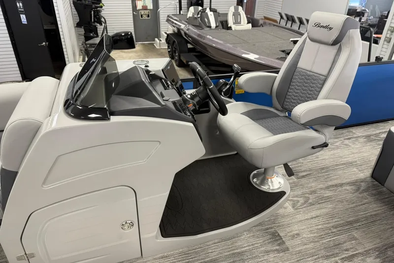 Slide: The Image of 2026 Bentley Pontoons Elite 223 Swingback helm with luxurious captain's chair and modern controls. - 6