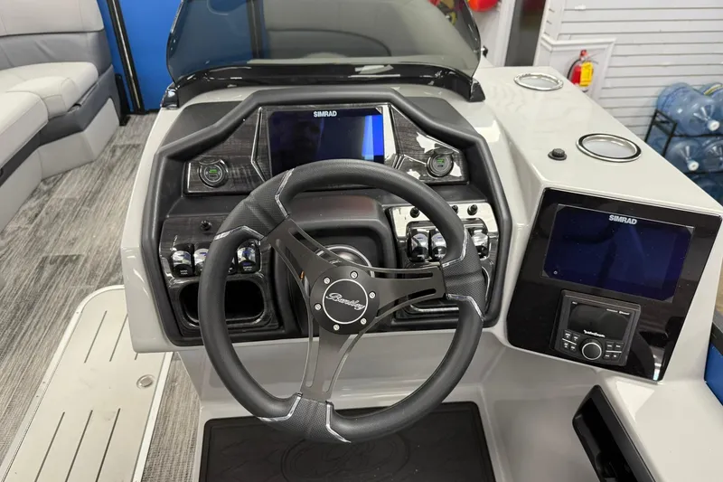 Slide: The Image of 2026 Bentley Pontoons Elite 223 Swingback dashboard with steering wheel and navigation displays. - 7