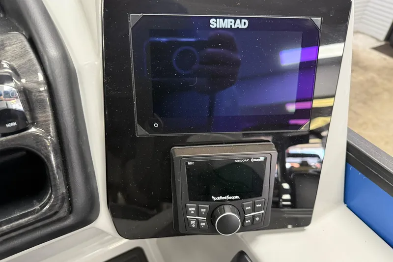 Slide: The Image of 2026 Bentley Pontoons Elite 223 Swingback dashboard with Simrad display and Rockford Fosgate controls. - 8