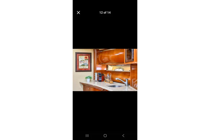 Slide: The Image of Luxurious kitchen interior of 2006 Sea Ray 500 Sundancer yacht with wooden cabinetry. - 5