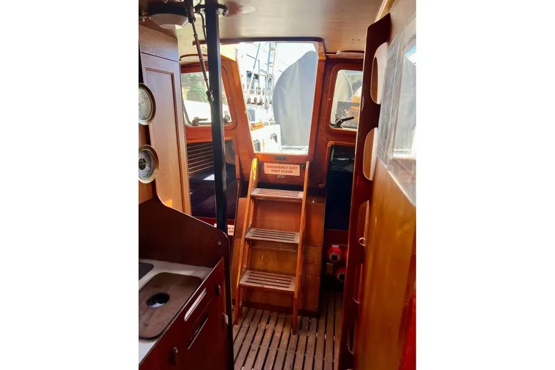 Slide: The Image of Interior of a 1982 Santa Cruz 50 sailboat, featuring wooden stairs and nautical design elements. - 12