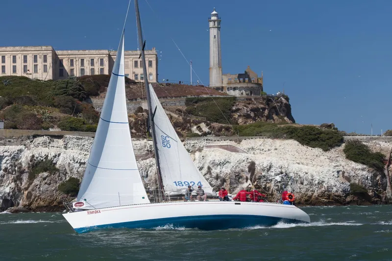 Slide: The Image of Sailboat Santa Cruz 50 (1982) cruising near Alcatraz Island with lighthouse in background. - 27