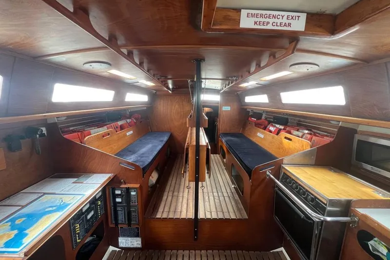 Slide: The Image of Interior of a 1982 Santa Cruz 50 sailboat with wooden furnishings and navigation equipment. - 9