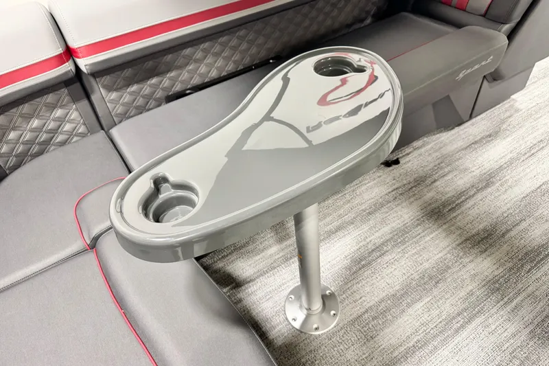 Slide: The Image of 2026 Bennington 20S Cruise interior with gray and red seating, featuring a sleek table design. - 6