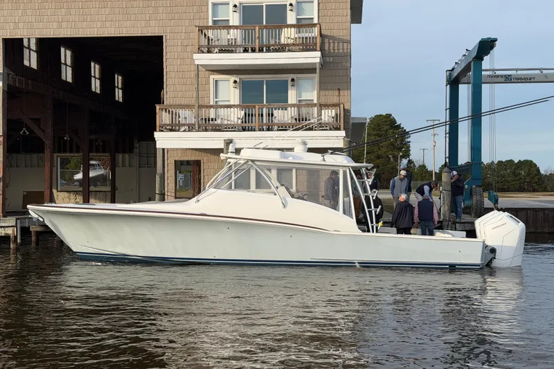 The Image of 2026 Albemarle 45 Carolinian Fisharound Express docked near a waterfront building. - 0