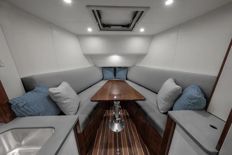 Slide: The Image of Manufacturer Provided Image: Luxurious interior of 2026 Albemarle 41 Carolinian Fisharound Express with cozy seating and elegant table. - 8
